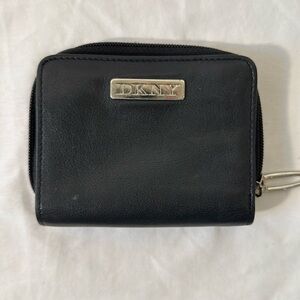 DKNY black zippered wallet. Silver hardware. 4” x 5”.